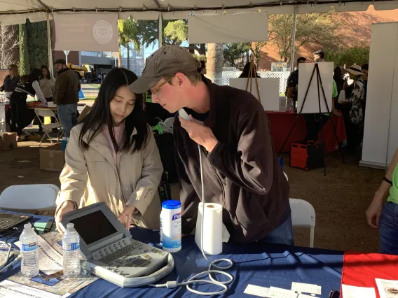 Students presenting linguistics technology at the Tucson Festival of Books.