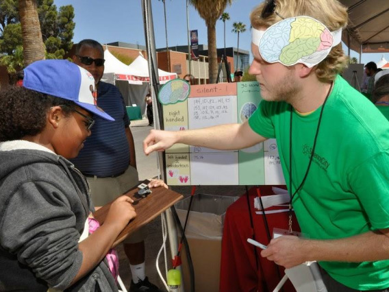 Linguistics student interacting with a community member at the Tucson Festival of Books.
