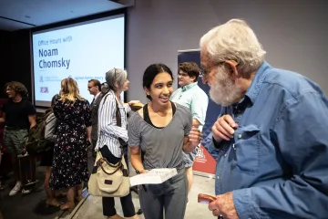 Noam Chomsky with a student signing her book